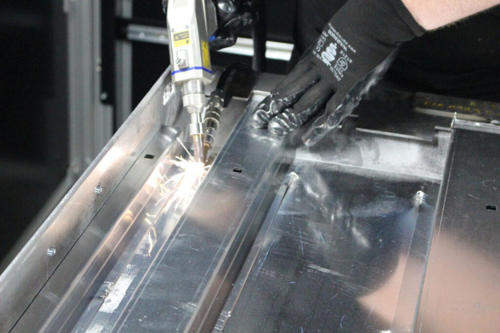 Laser welding services at Unifabs operator with handheld laser welding gun welds aluminium fabrication