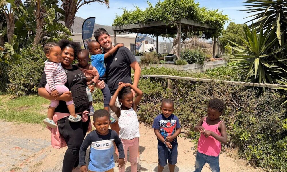 Jason Austin, Unifabs Chief Executive, with Trina and children from Siyakhula Nursery