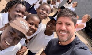 Jason Austin visit to Bhongolethu School Rugby Day 2025 having selfie with a group of children at the primary school