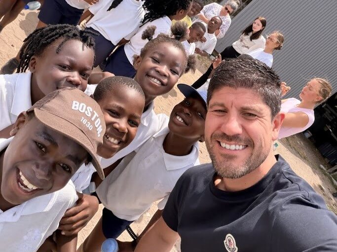 Jason Austin visit to Bhongolethu School Rugby Day 2025 having selfie with a group of children at the primary school