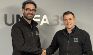 Gary Moreton achieves 10 years' service milestone at UK sheet Metal Fabricator Unifabs Ltd. Pictured with Andy Tuck shaking hands in front of a Unifabs sign on a grey wall.